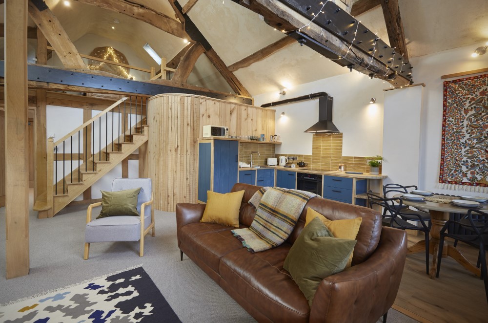 Flat 3 (kin rooms) showing the open plan kitchen / sitting room, with stairs to the mezzanine