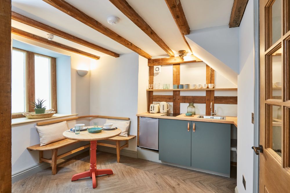 The oak-framed kitchen with corner seating by a north-facing window