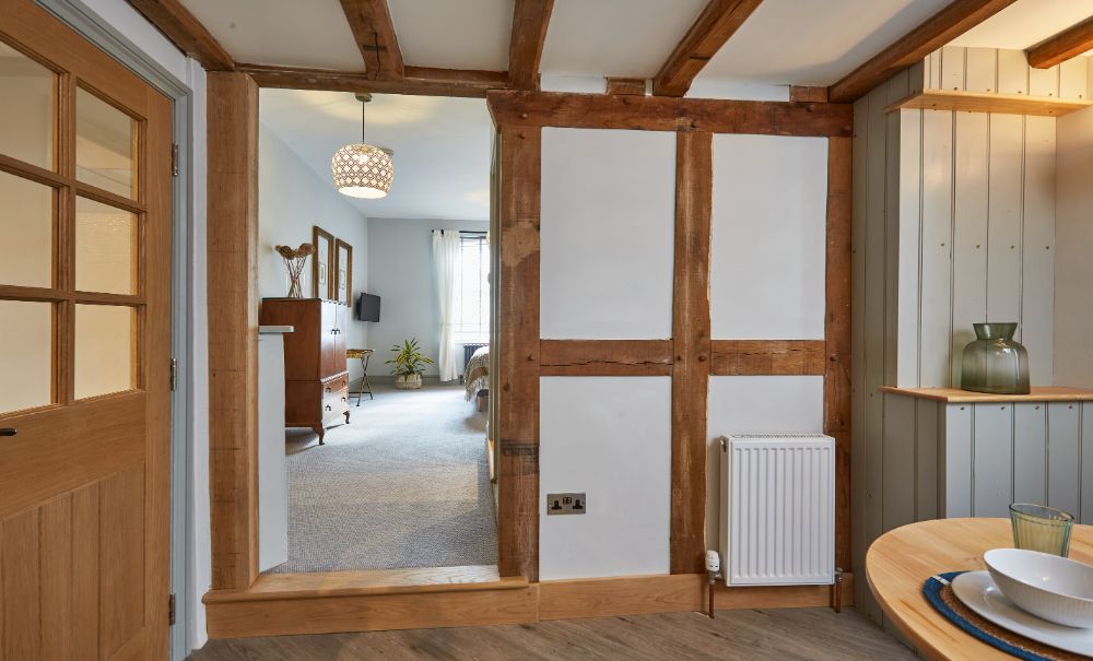 A view from the kitchen to the bedroom through beautiful oak-framed walls