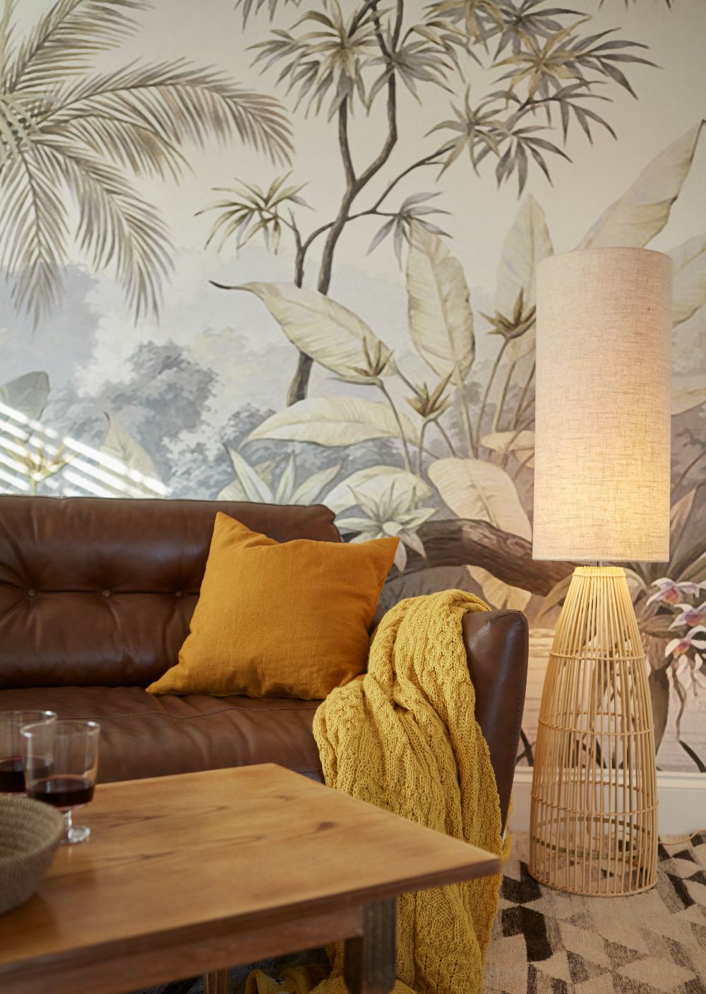 A warm glow from the floor lamp beside the sofa